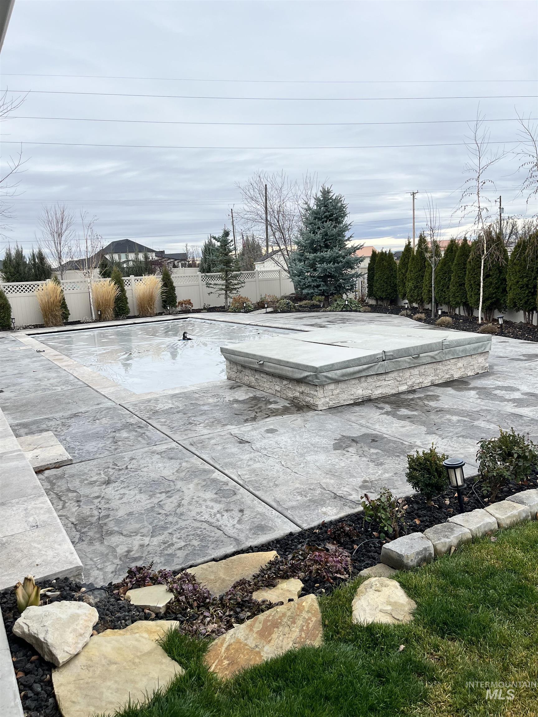 Fenced backyard featuring an outdoor pool