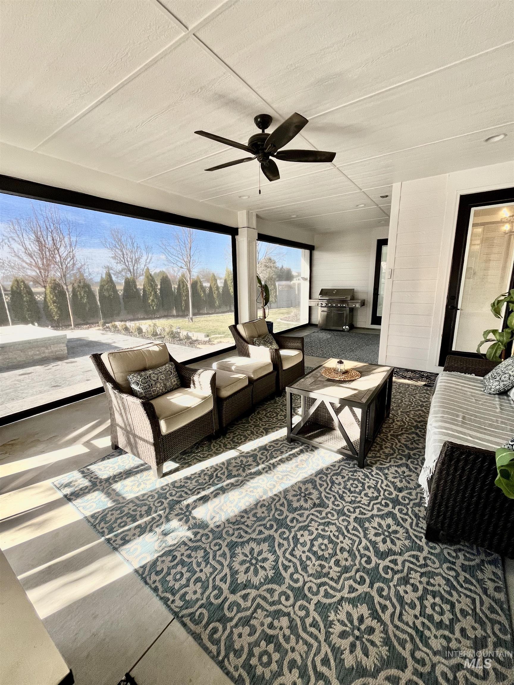 View of patio featuring a ceiling fan, a grill, and outdoor lounge area