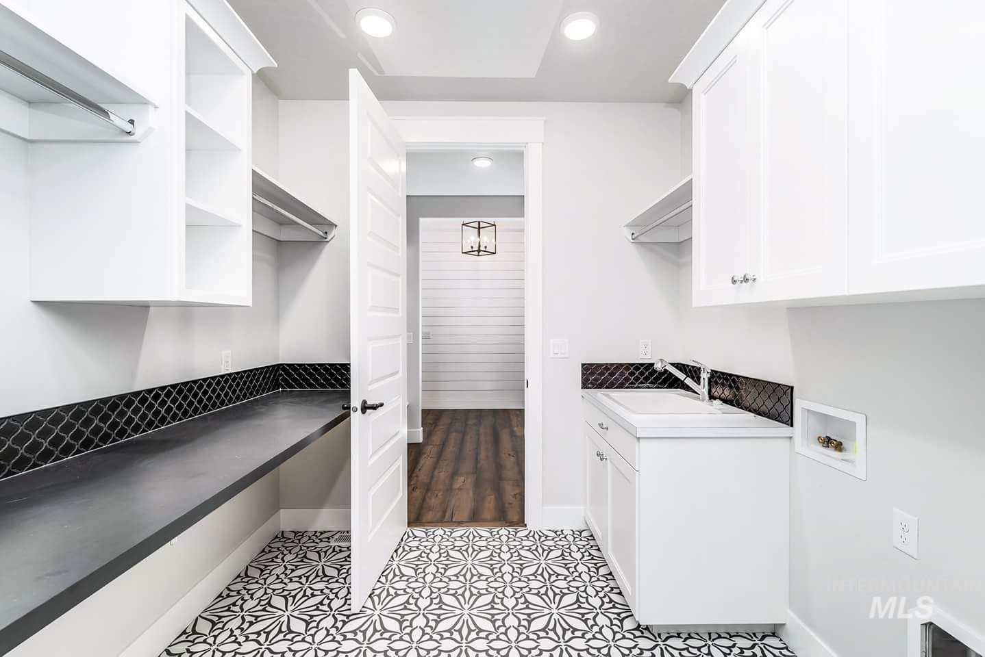 Laundry room with light tile patterned flooring, hookup for a washing machine, cabinet space, and recessed lighting