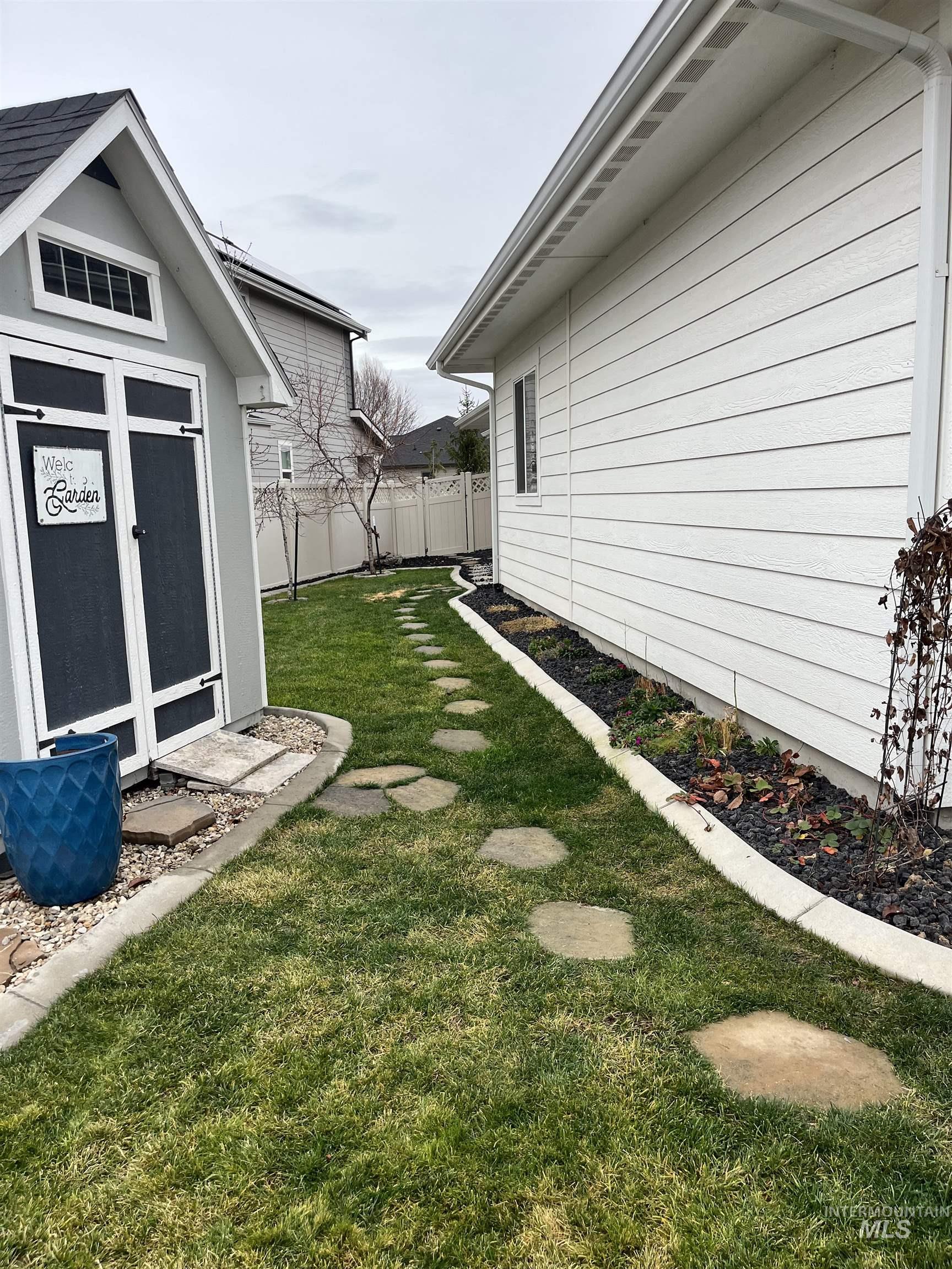 View of yard with a storage unit