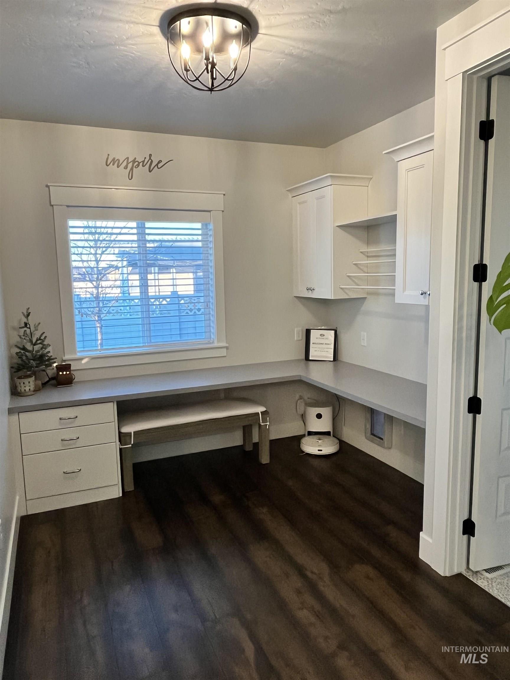 Pocket office between kitchen and flex room features large cabinets with gift wrap station and drawer/file cabinet.