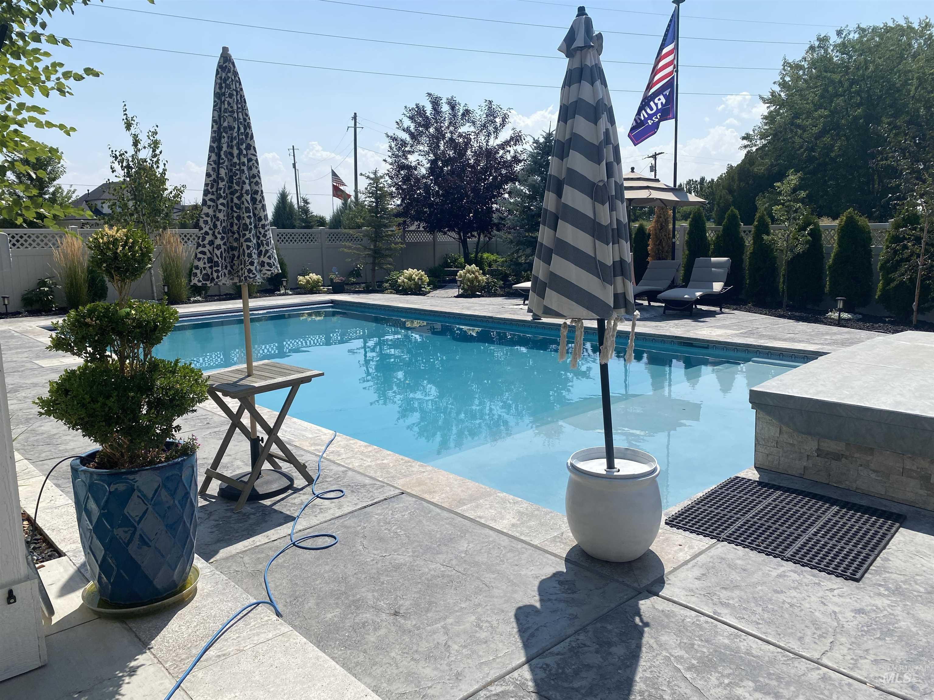 View of swimming pool with a patio and a fenced backyard