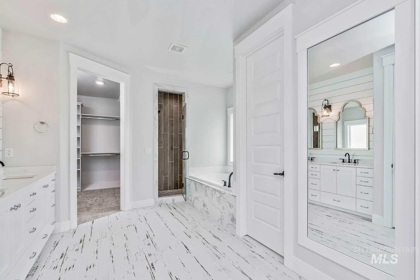 Master Bathroom with vanity, recessed lighting, a bath, a marble finish shower, and a spacious closet