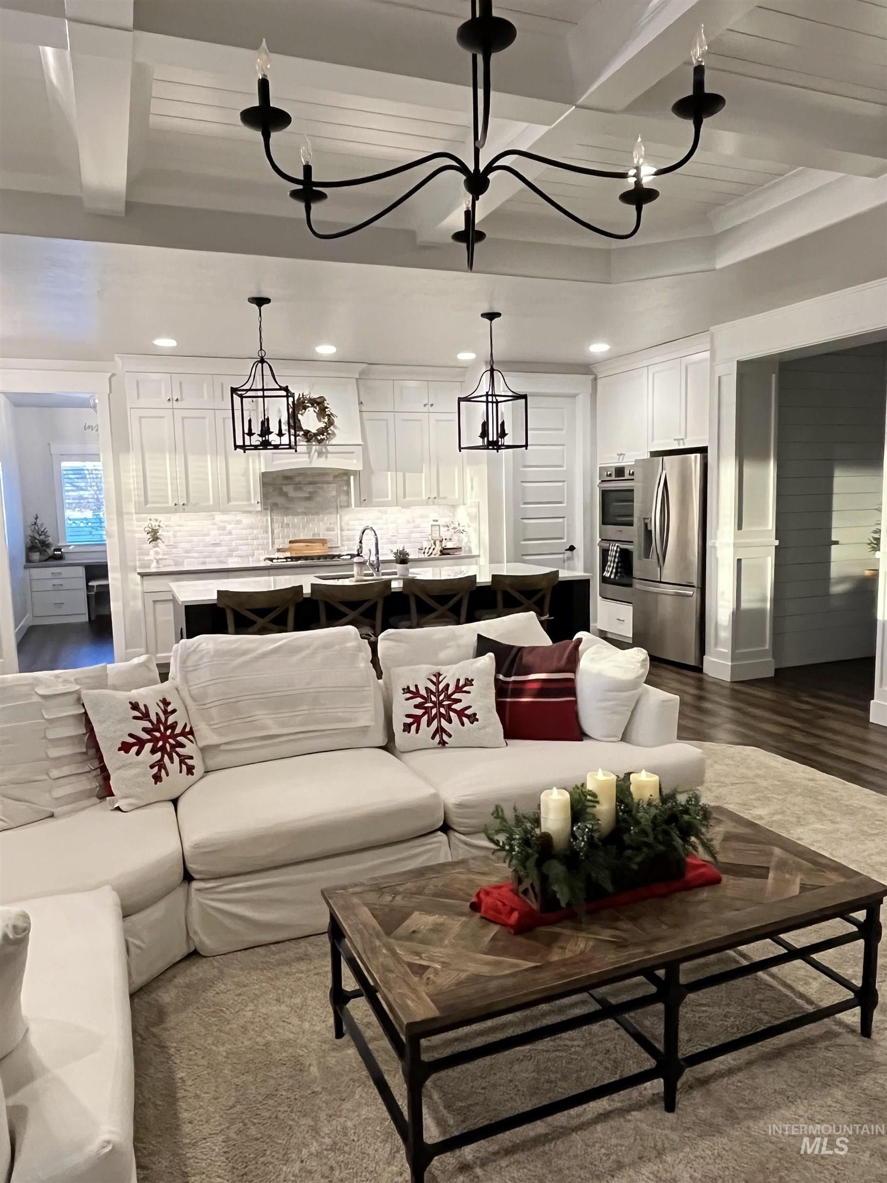 Living area featuring a chandelier and beamed ceiling