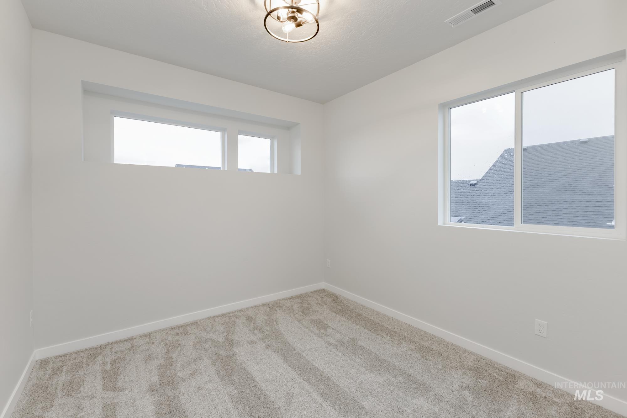 Carpeted empty room with baseboards