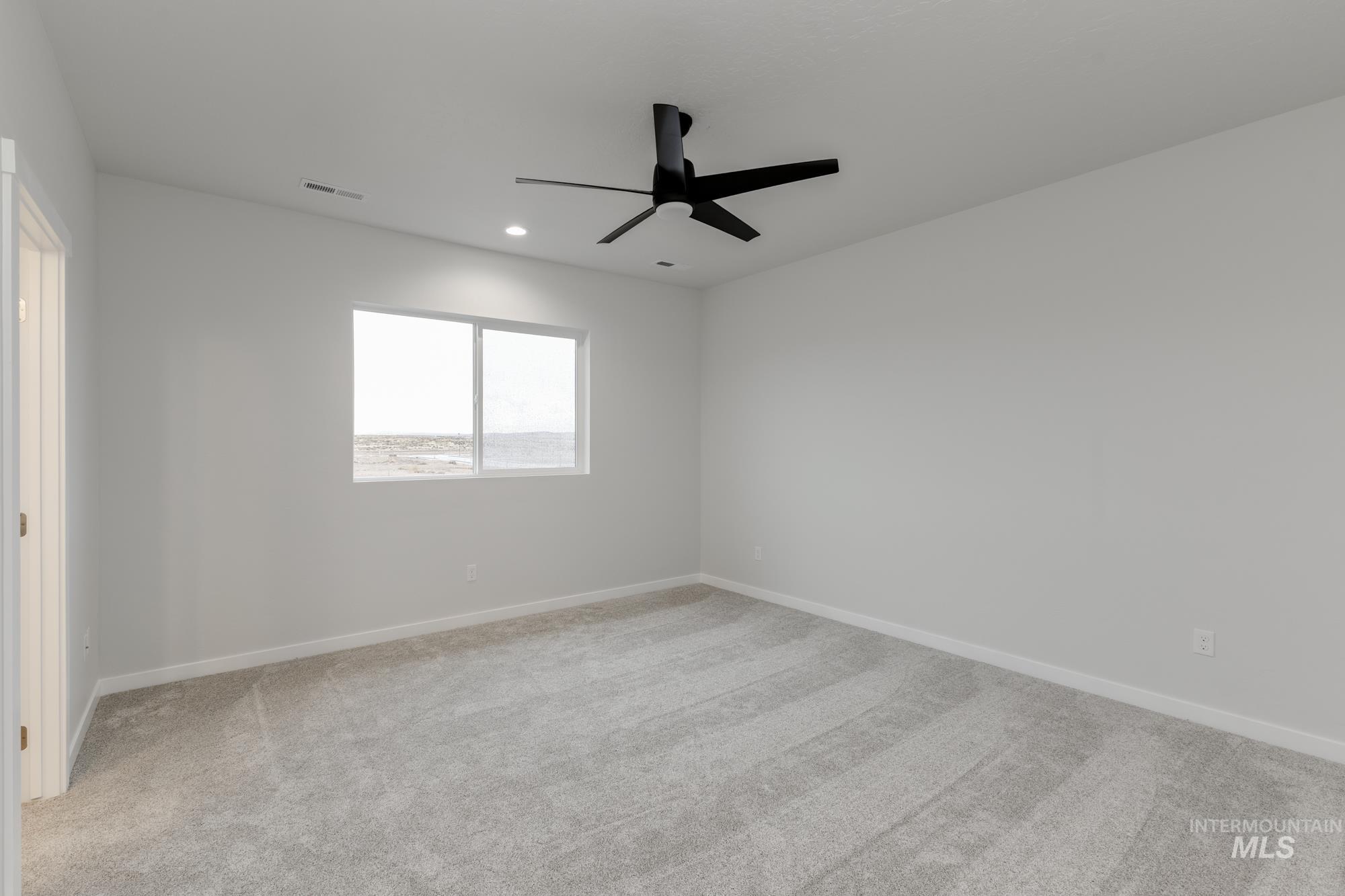 Unfurnished room with light carpet, a ceiling fan, and recessed lighting