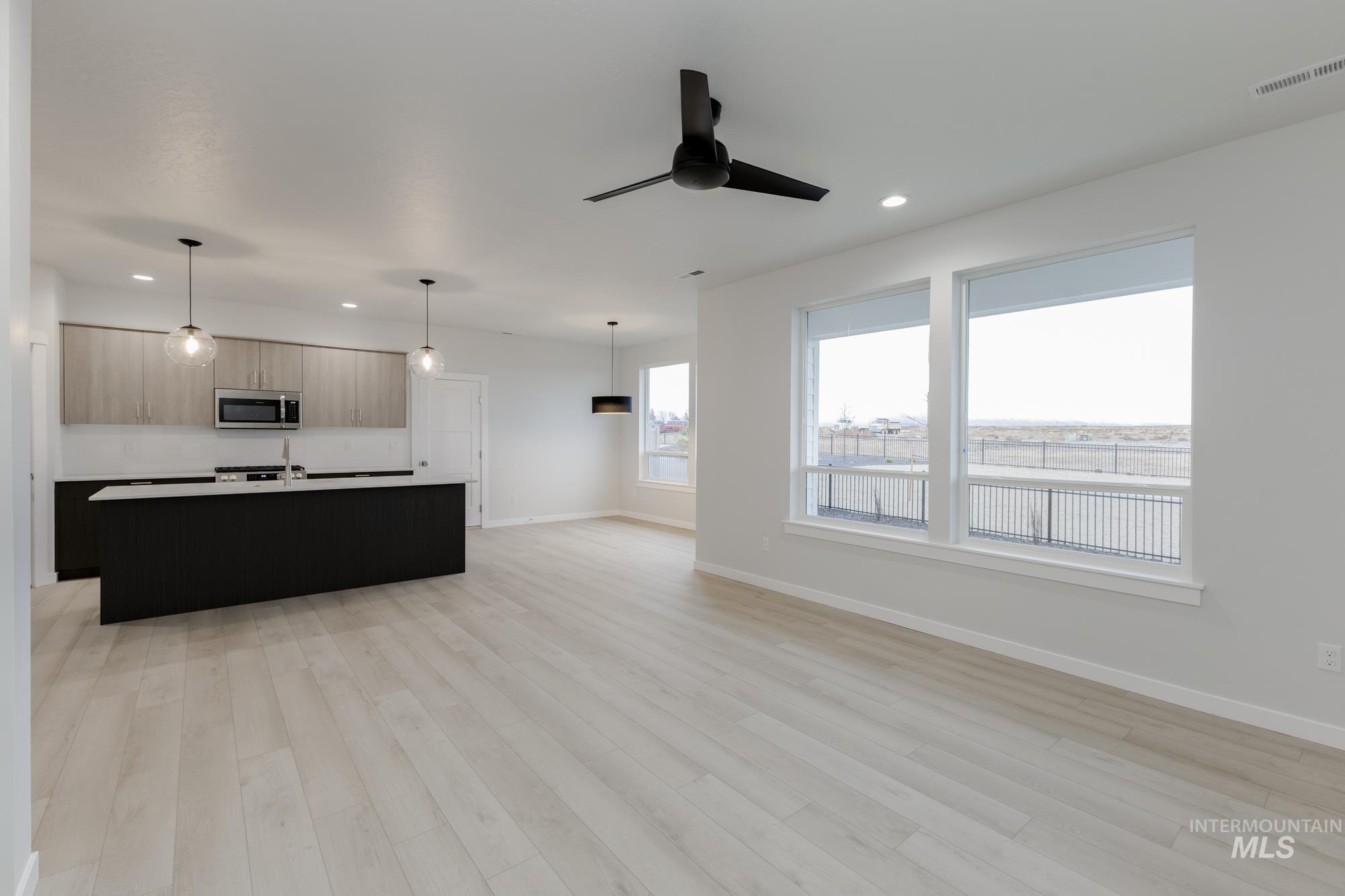 Unfurnished living room with recessed lighting, light wood-style floors, and a ceiling fan