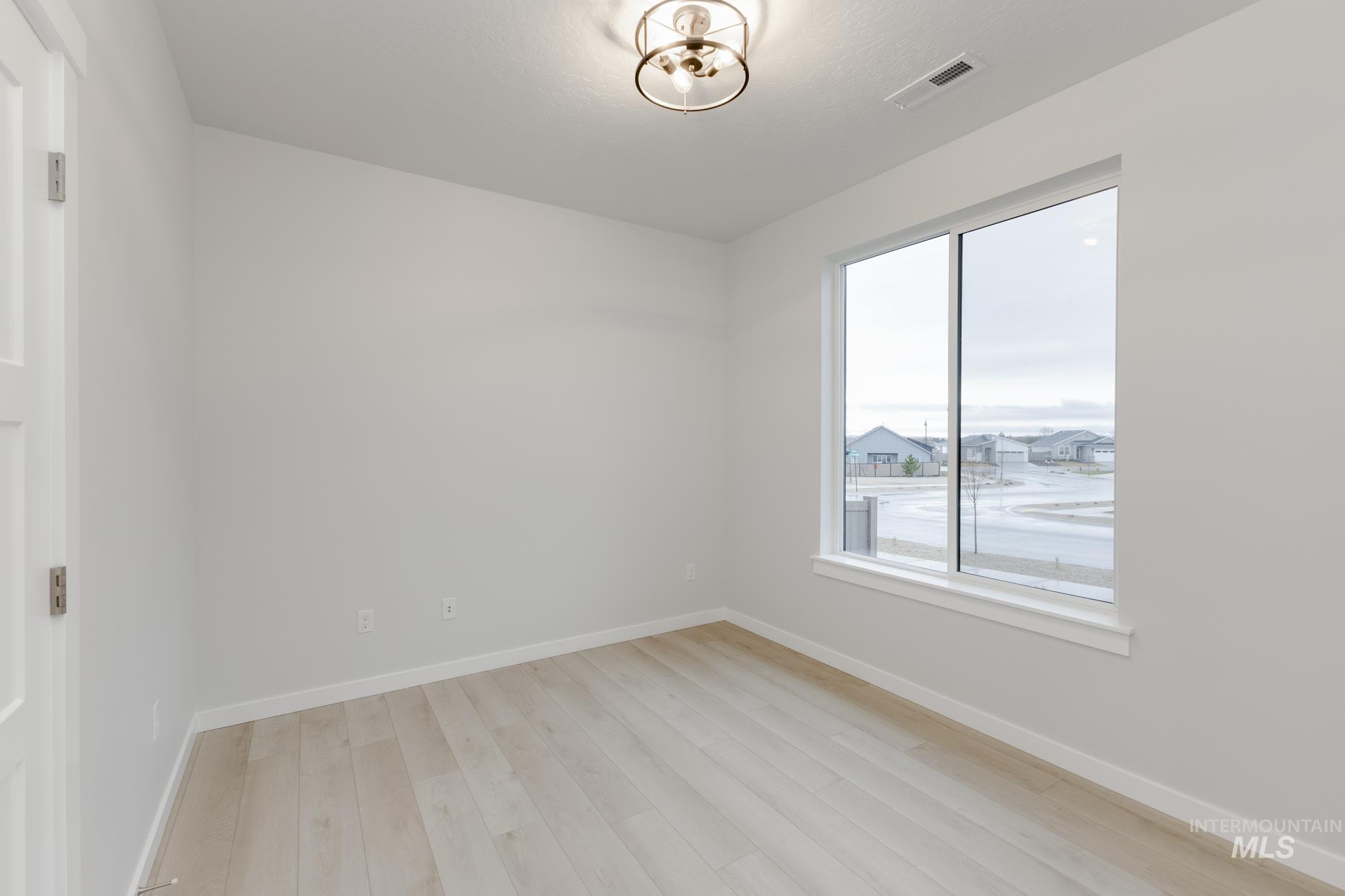 Empty room featuring light wood-style flooring and baseboards