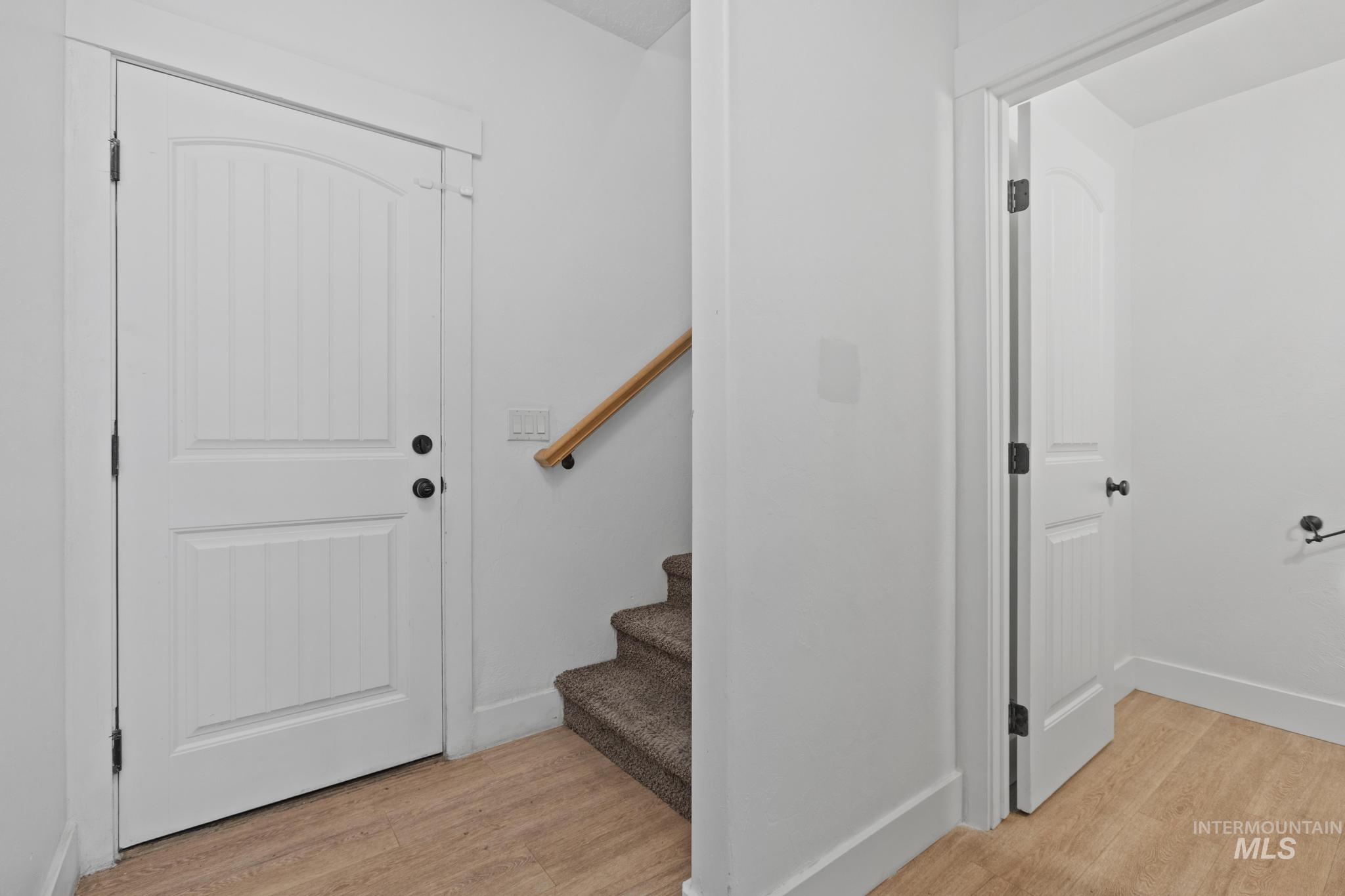Staircase featuring wood finished floors