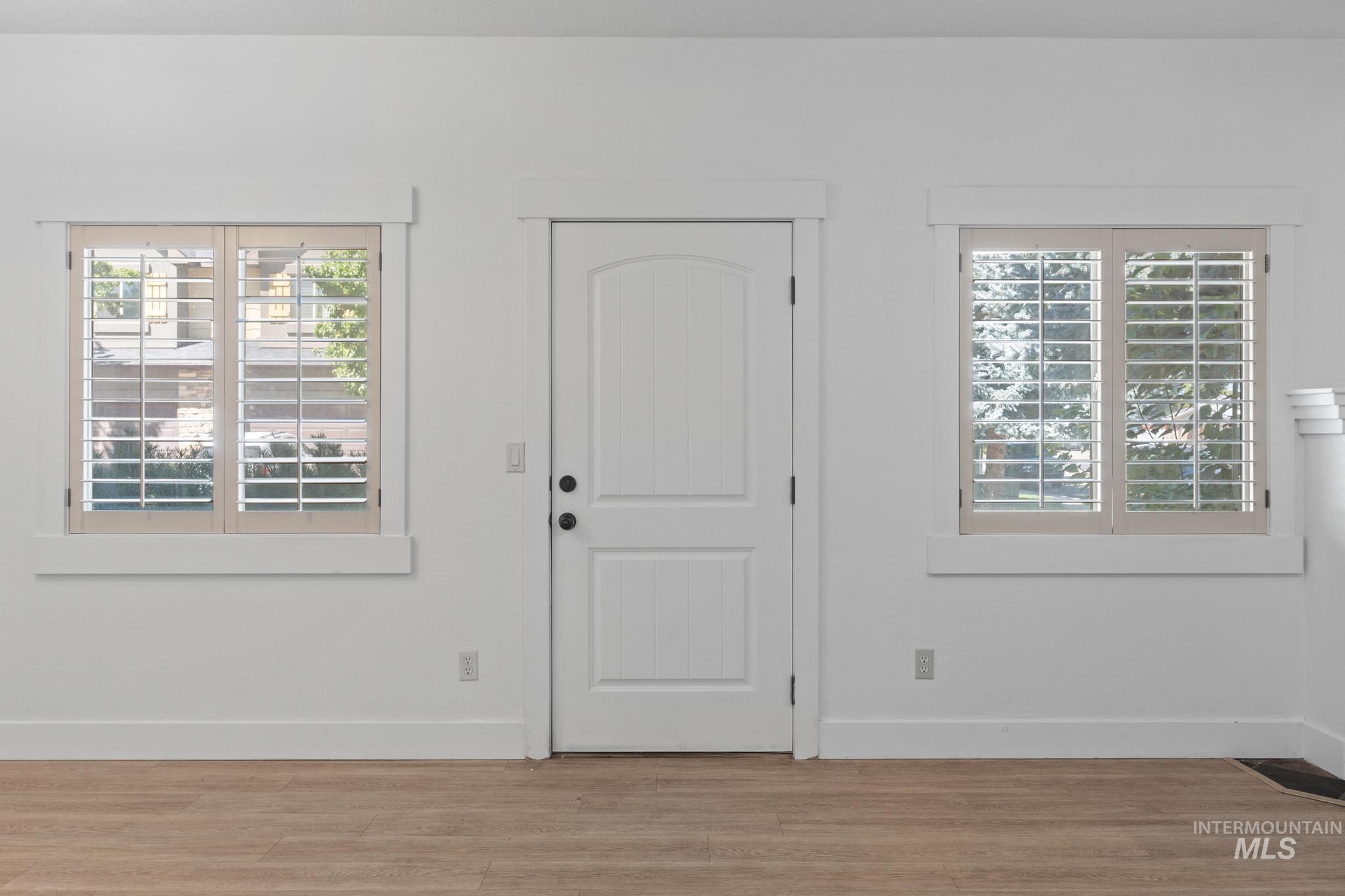 Foyer featuring baseboards and light wood-type flooring