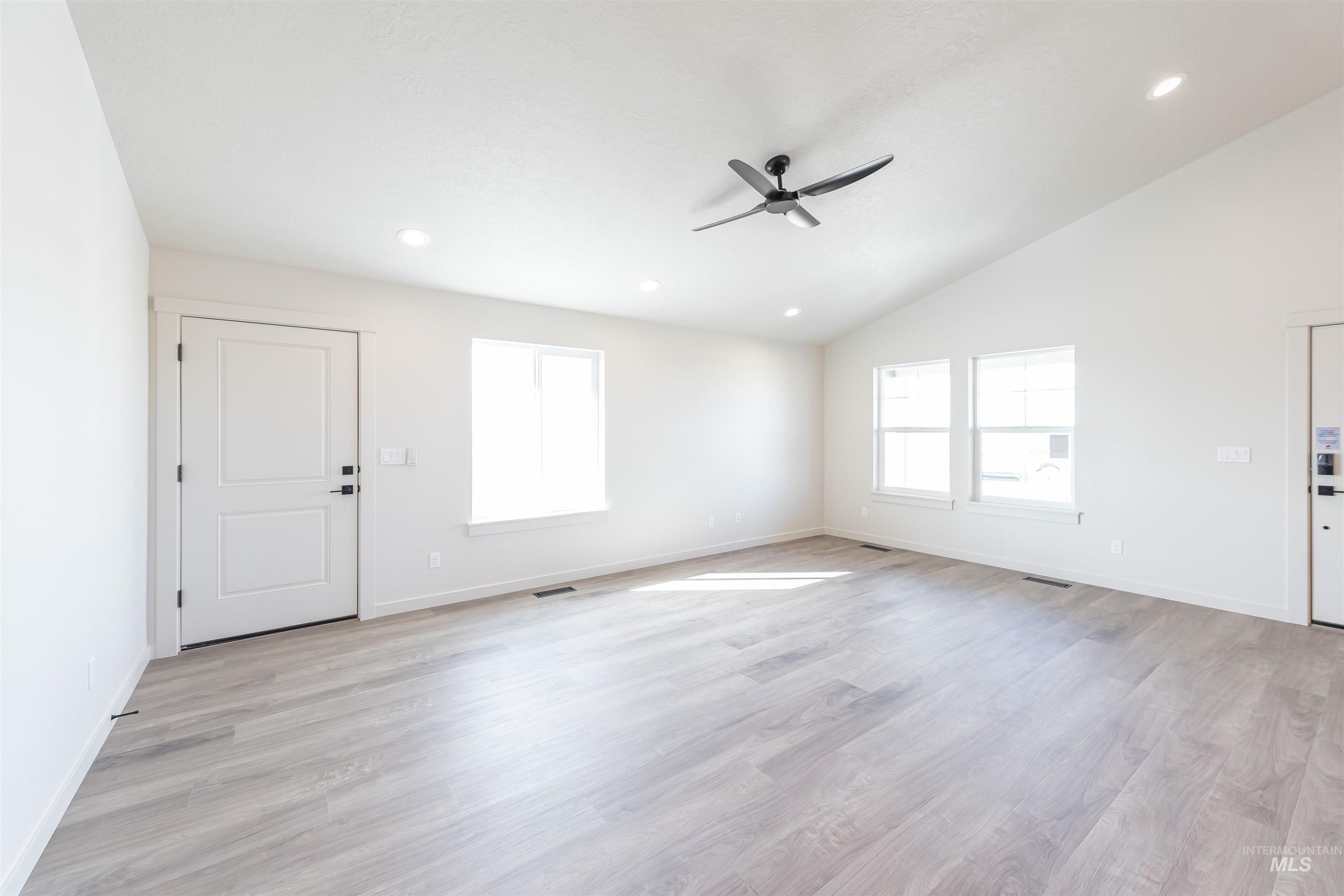 Spare room with recessed lighting, light wood-type flooring, lofted ceiling, and ceiling fan
