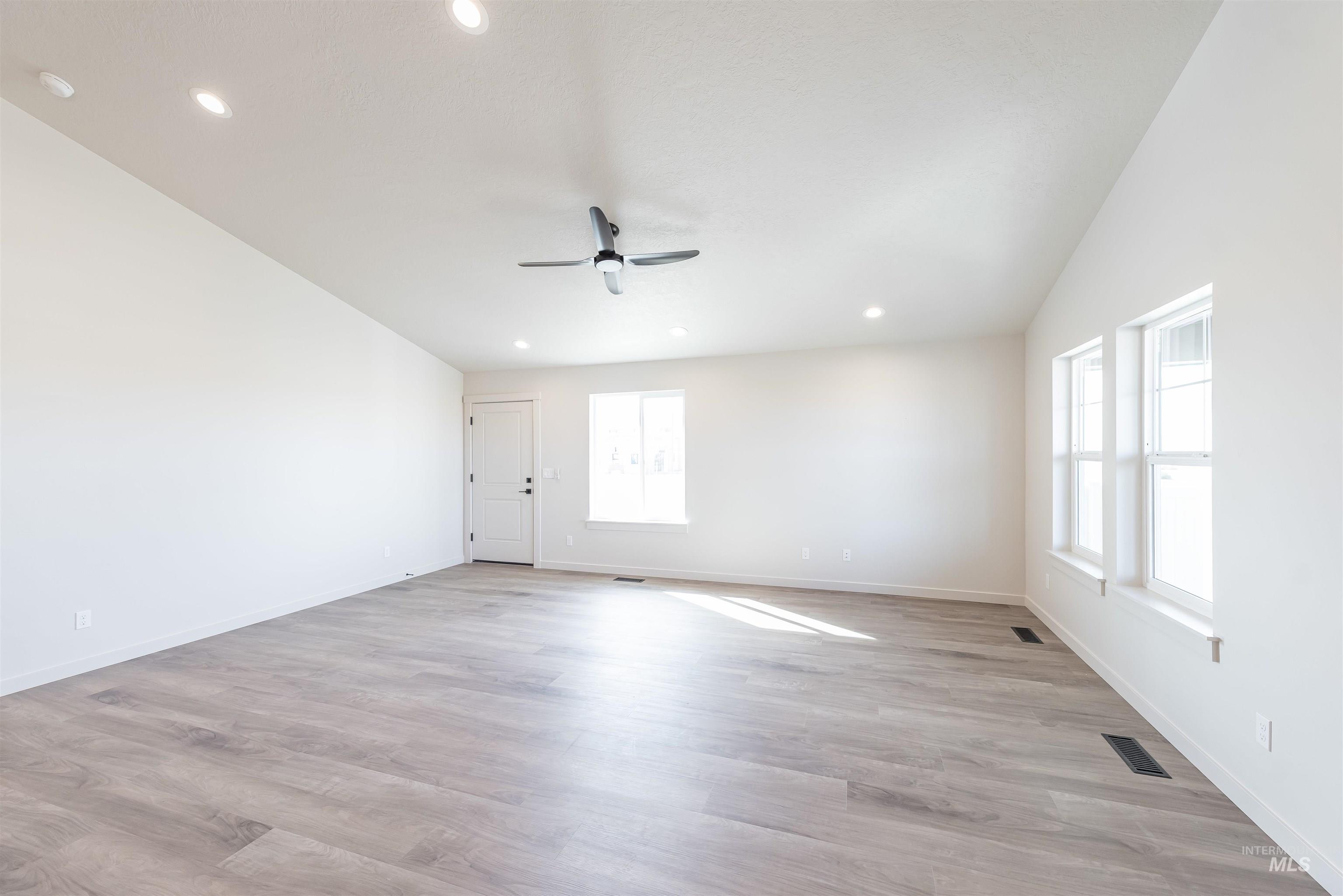 Spare room featuring recessed lighting, light wood-style flooring, and a ceiling fan