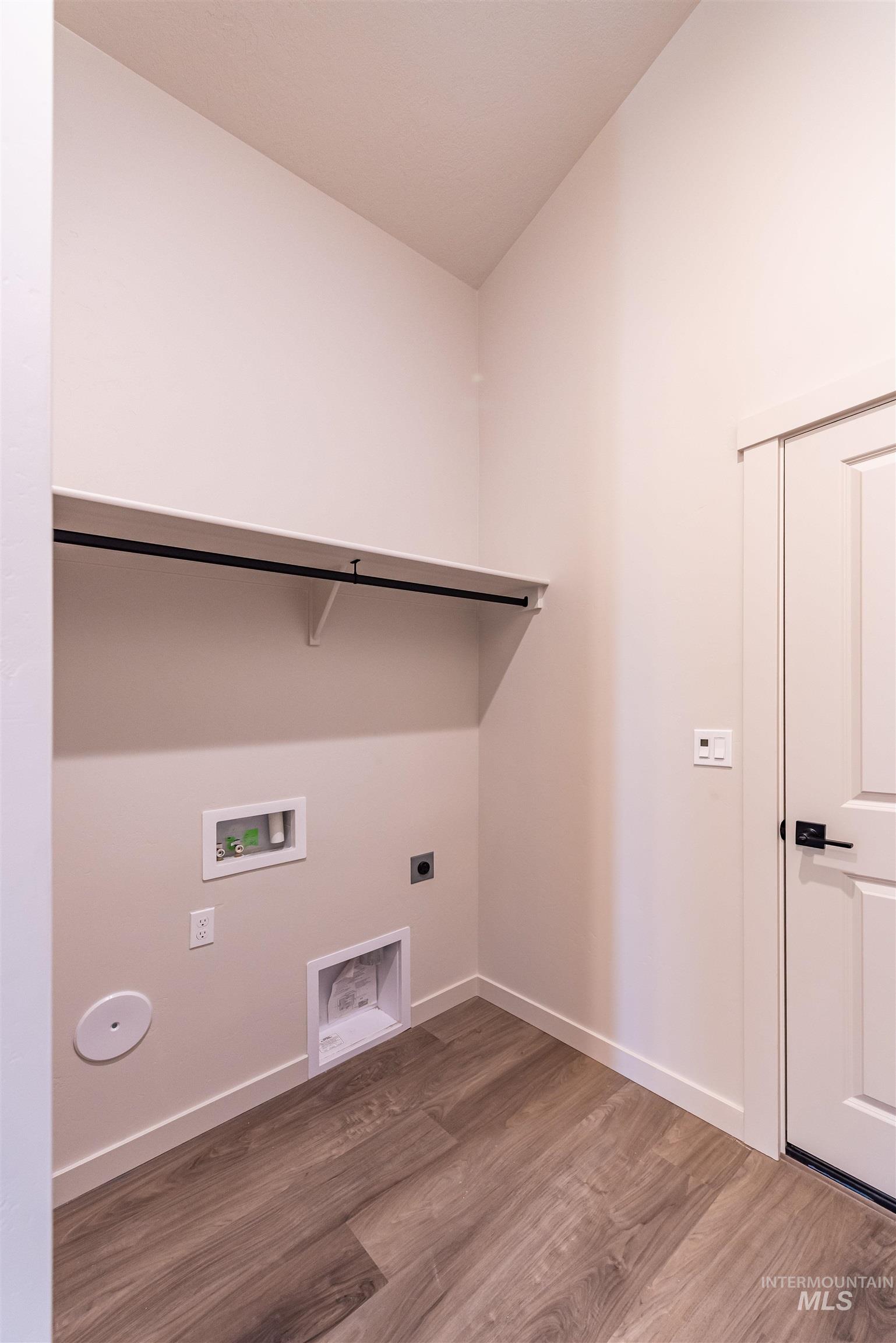 Laundry area featuring light wood-style flooring, electric dryer hookup, and hookup for a washing machine