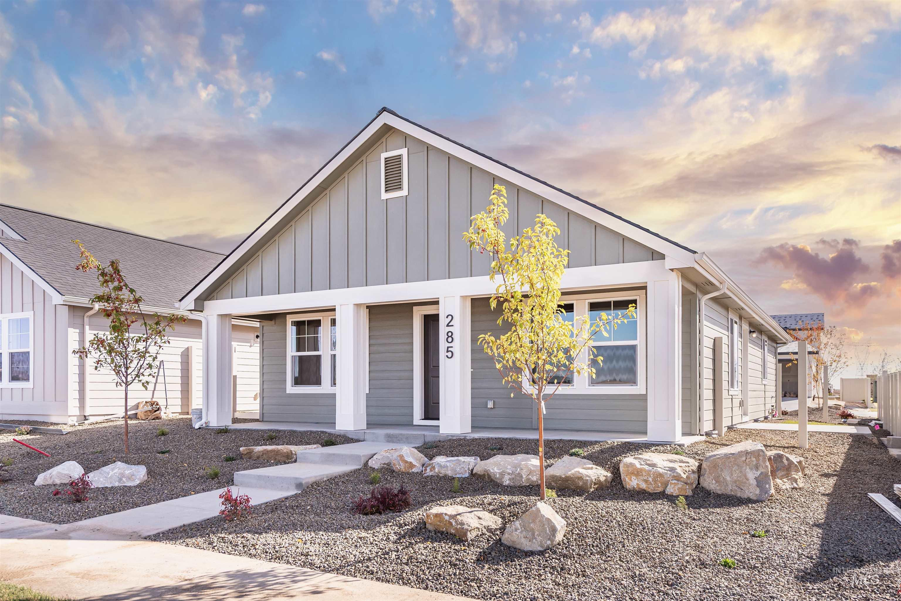 View of front facade featuring board and batten siding and a porch