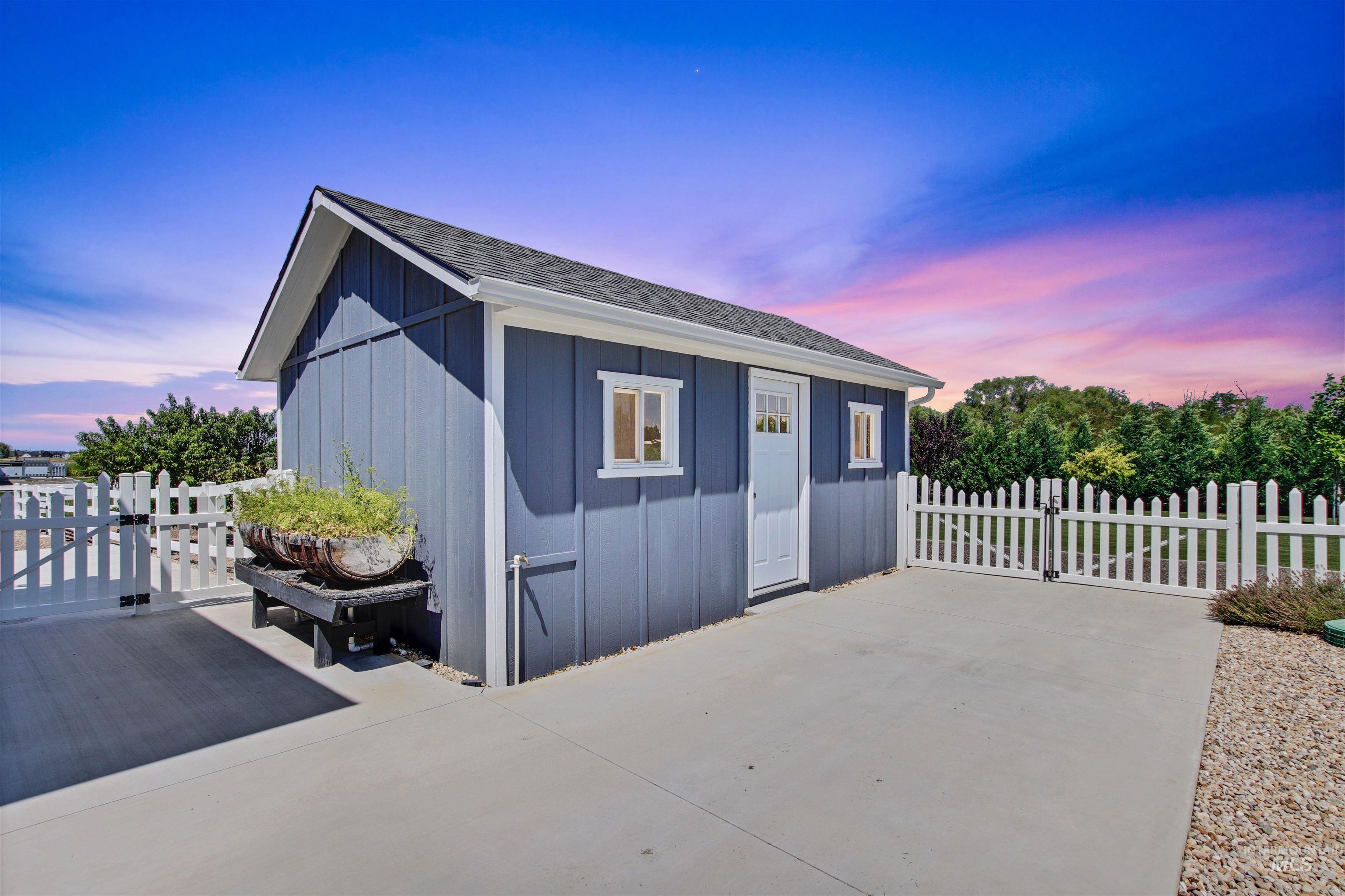 Outdoor structure at dusk featuring a gate