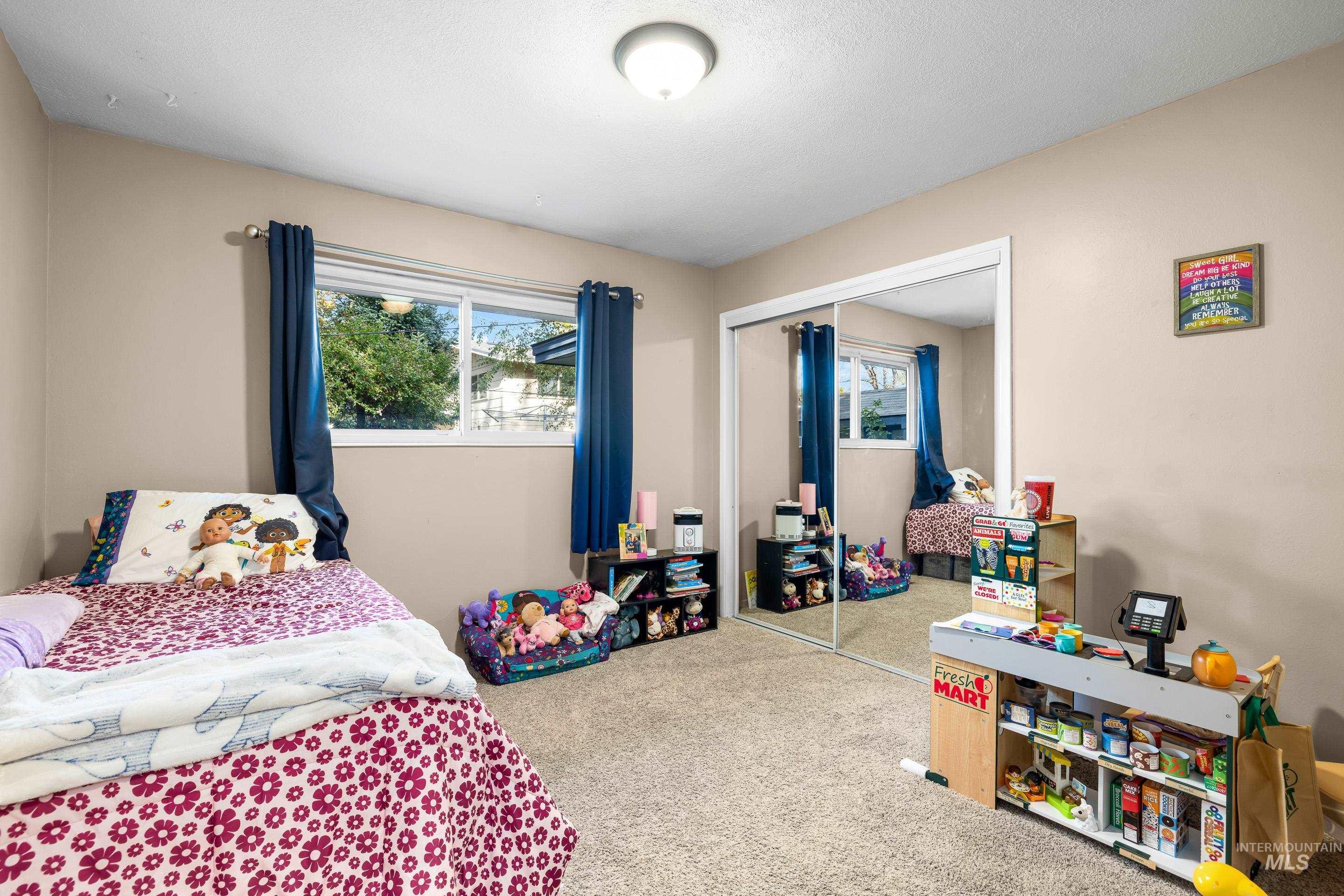 Bedroom with carpet and a closet