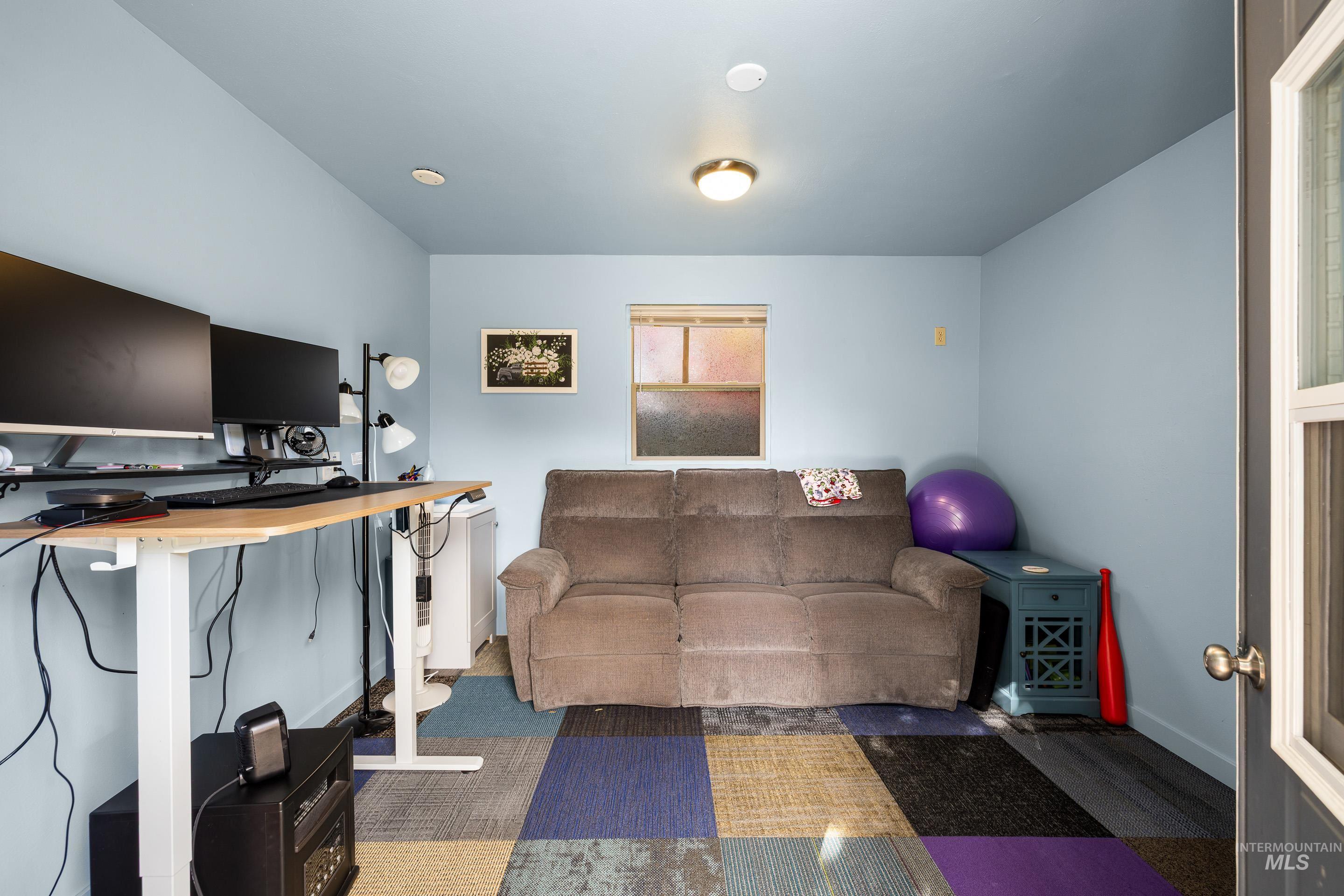Office area with carpet flooring and baseboards