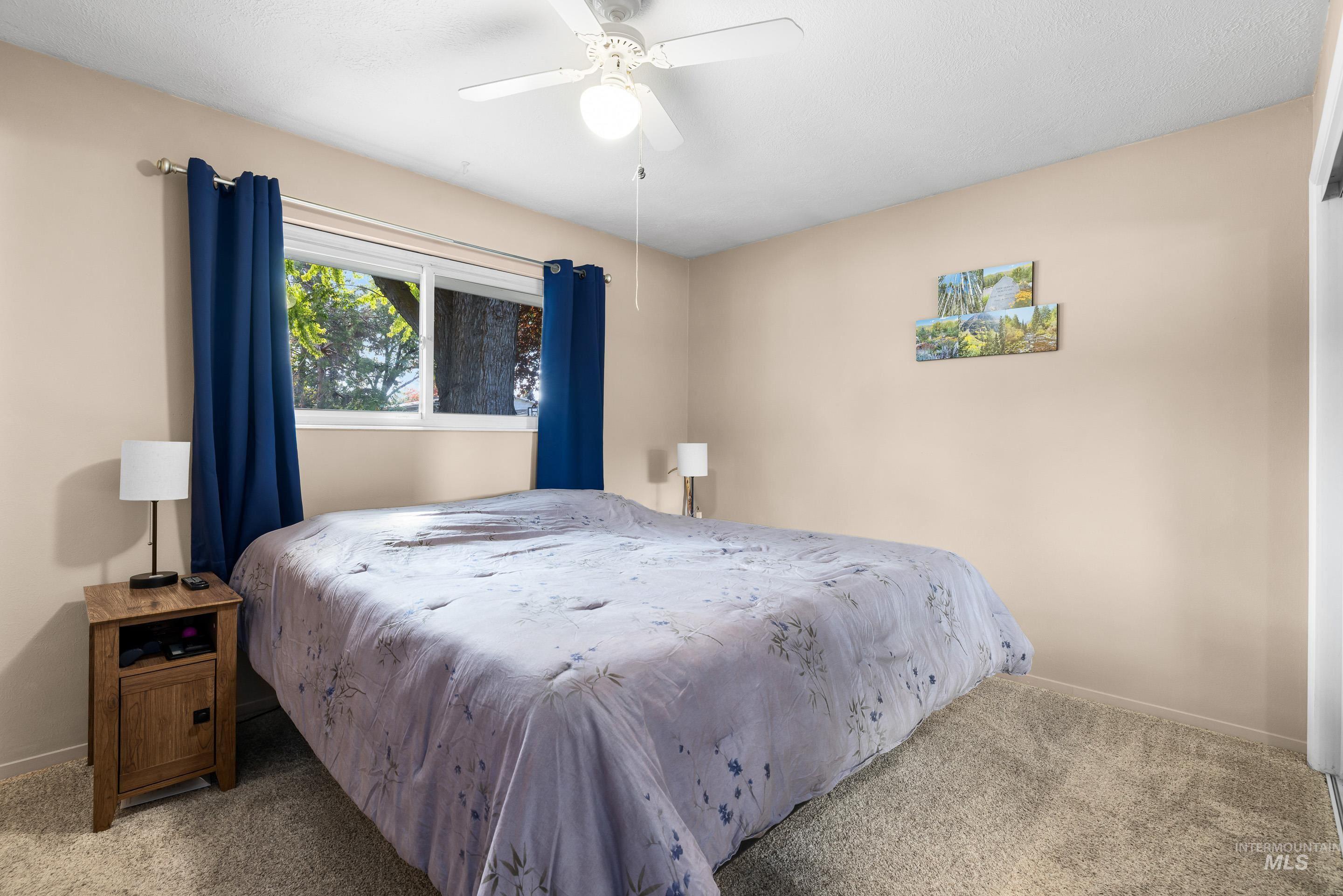 Bedroom featuring carpet and ceiling fan