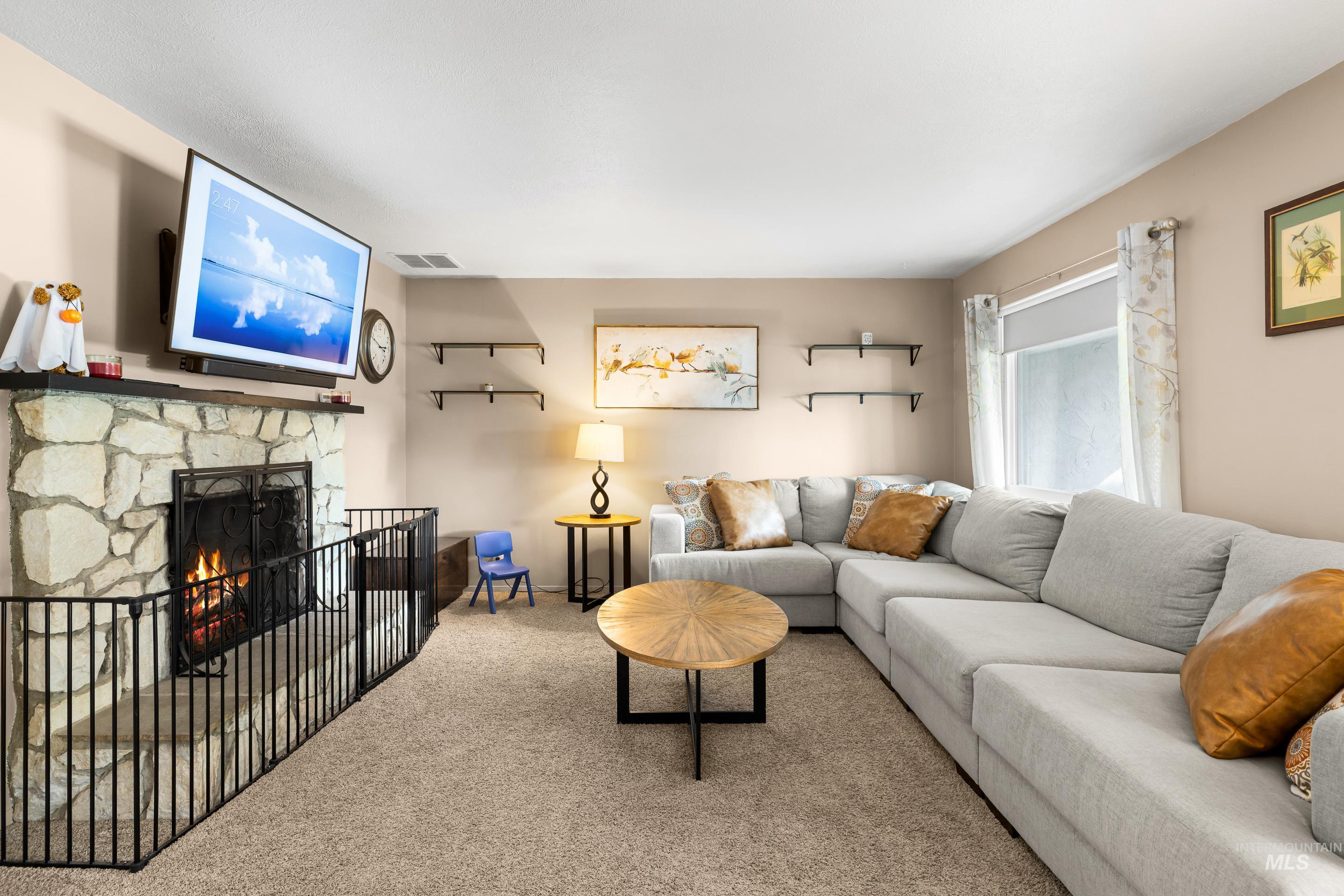 Carpeted living area with a fireplace