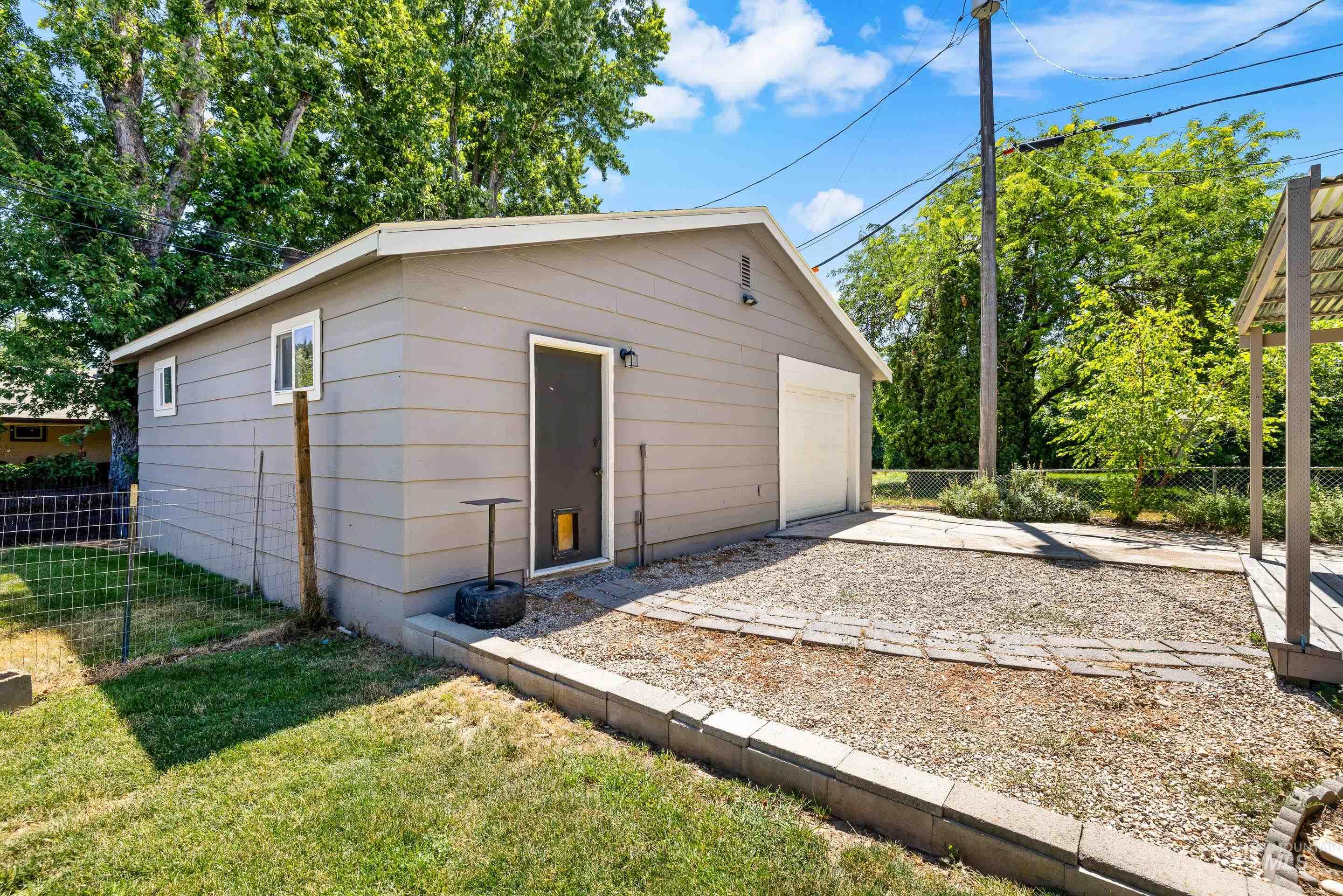 Detached garage featuring concrete driveway