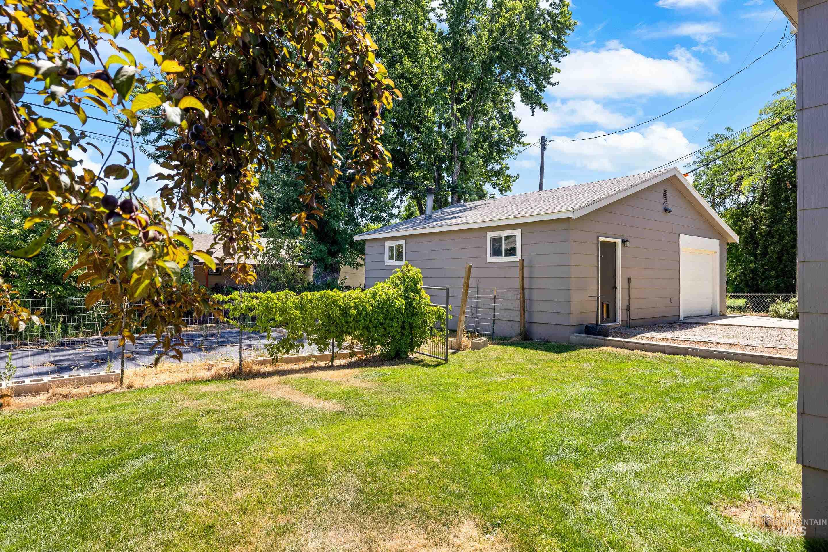 View of yard with an outbuilding and a garage