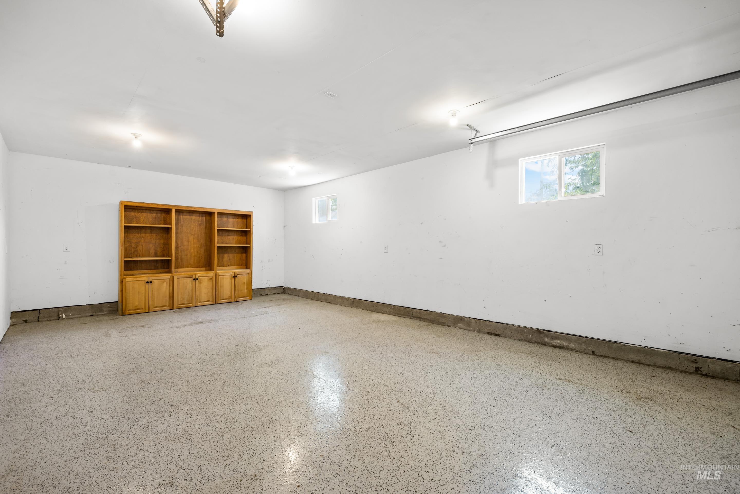Garage featuring baseboards