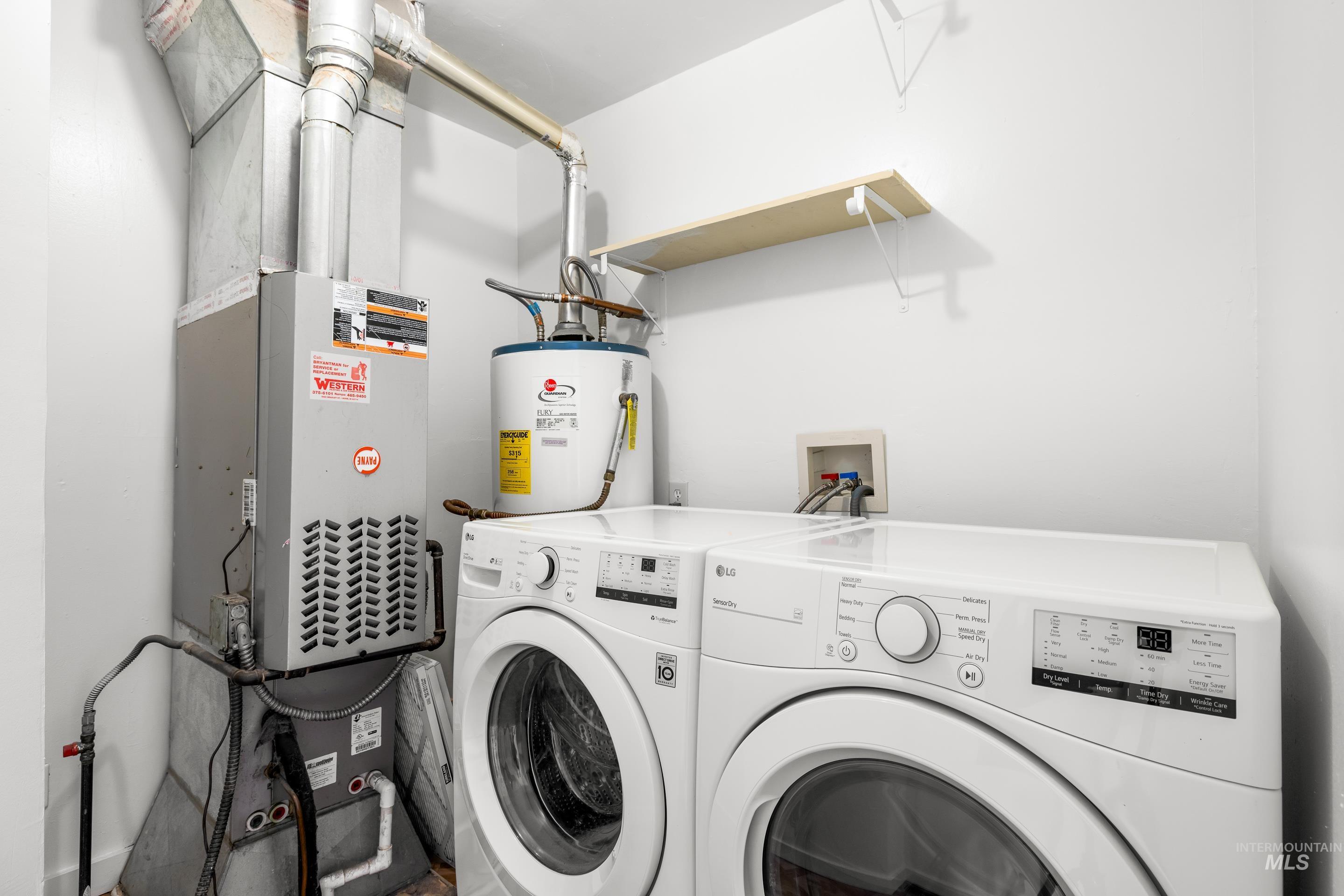 Washroom with washer and dryer, water heater, and heating unit