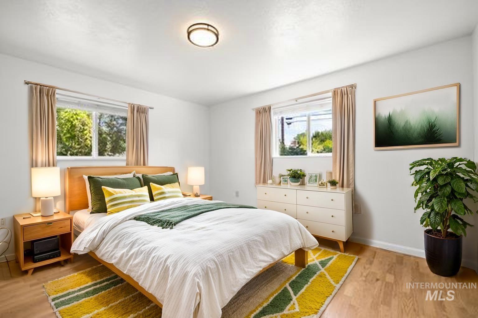 Bedroom featuring light wood-style floors and baseboards