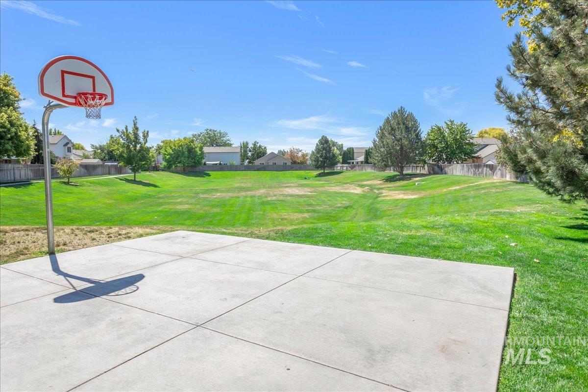 View of sport court featuring basketball court and a patio area