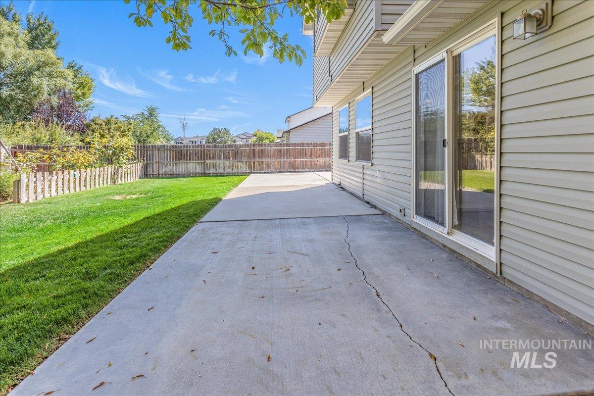Fenced backyard featuring a patio