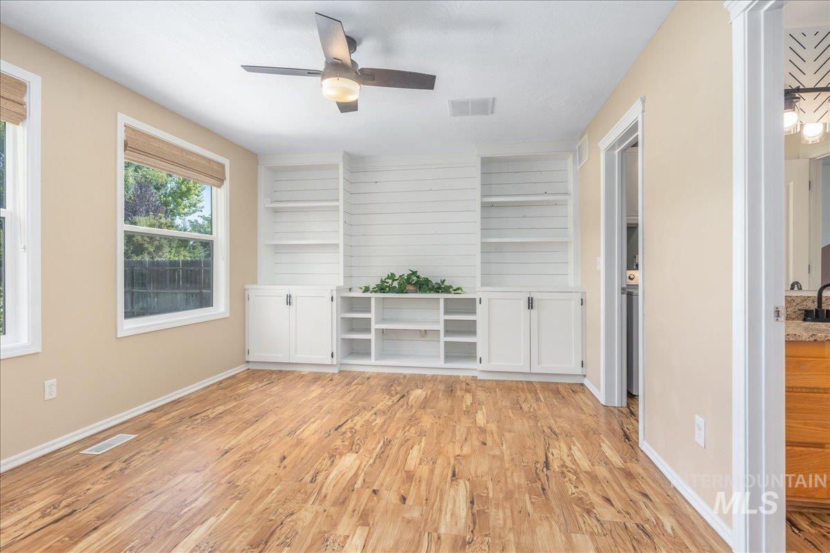 Unfurnished room featuring light wood-style floors and a ceiling fan