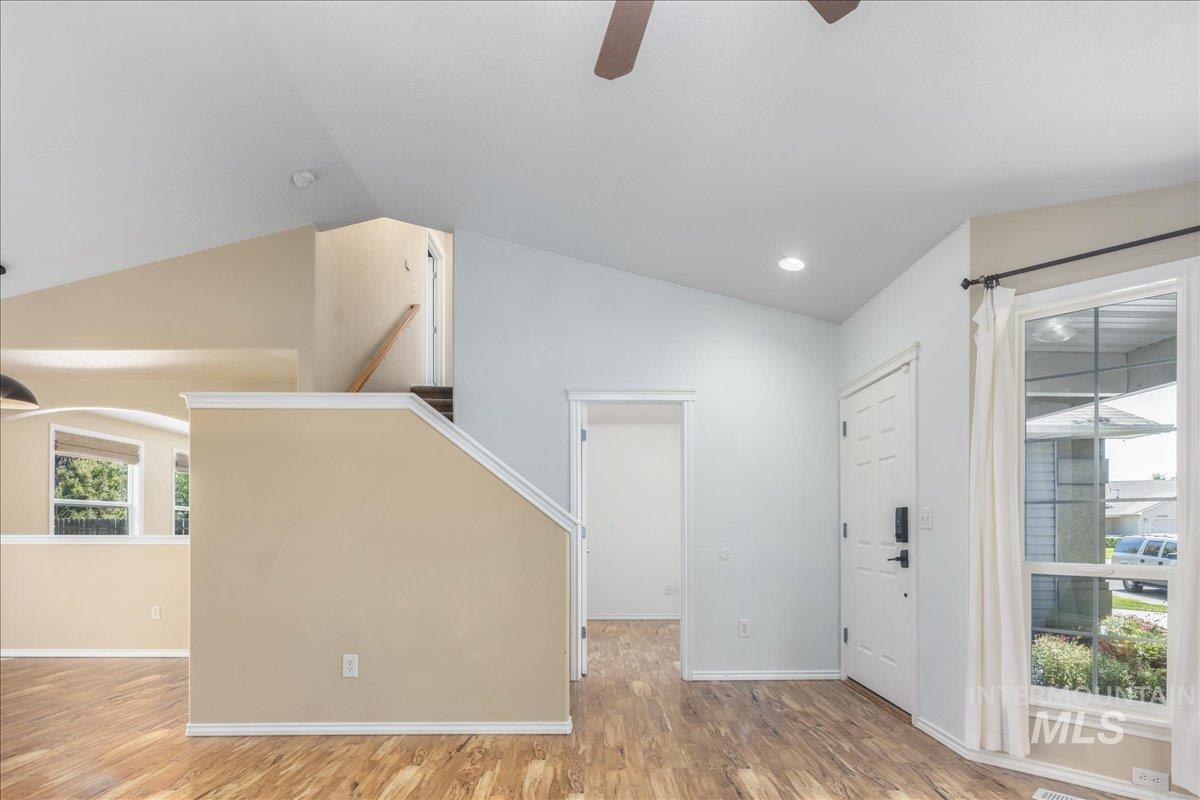 Foyer entrance with light wood-style floors, vaulted ceiling, a ceiling fan, and recessed lighting