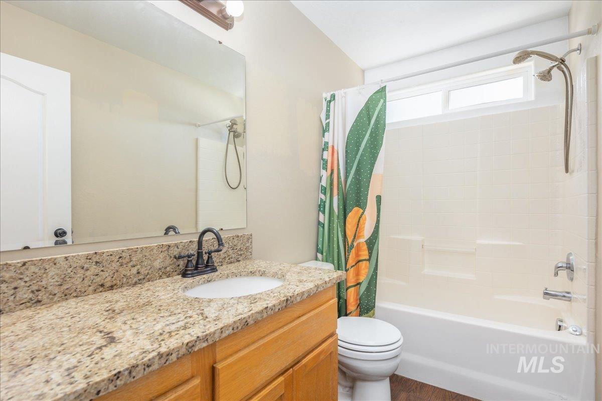 Bathroom with shower / bath combo and vanity