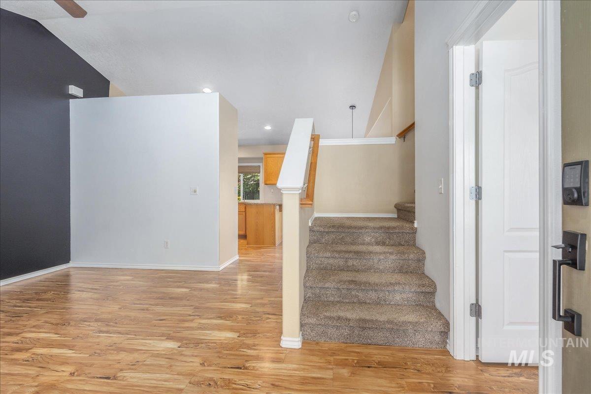 Stairway featuring wood finished floors and recessed lighting