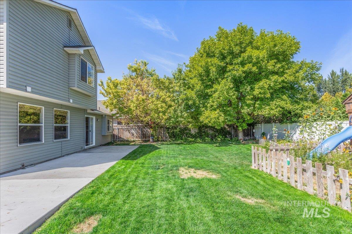 Fenced backyard with a patio