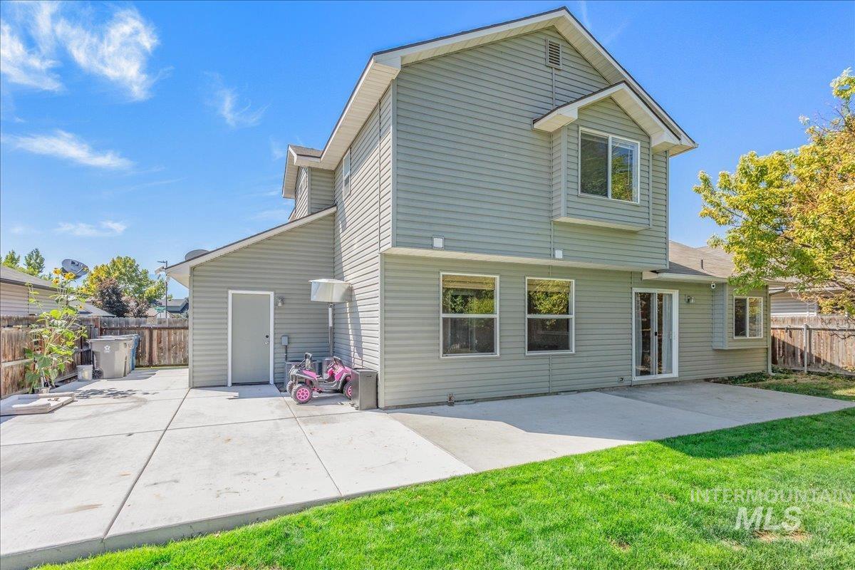 Back of property with a patio and a fenced backyard