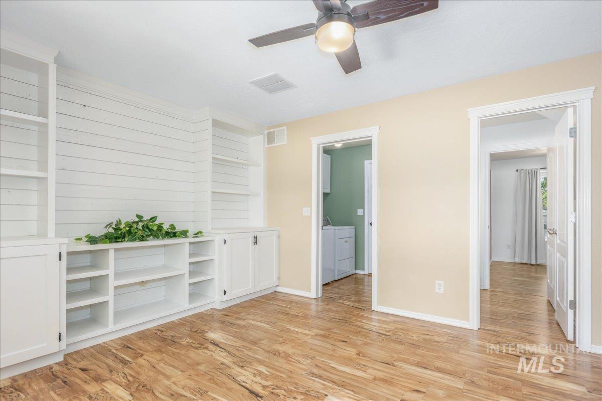 Unfurnished room with light wood-style flooring and ceiling fan