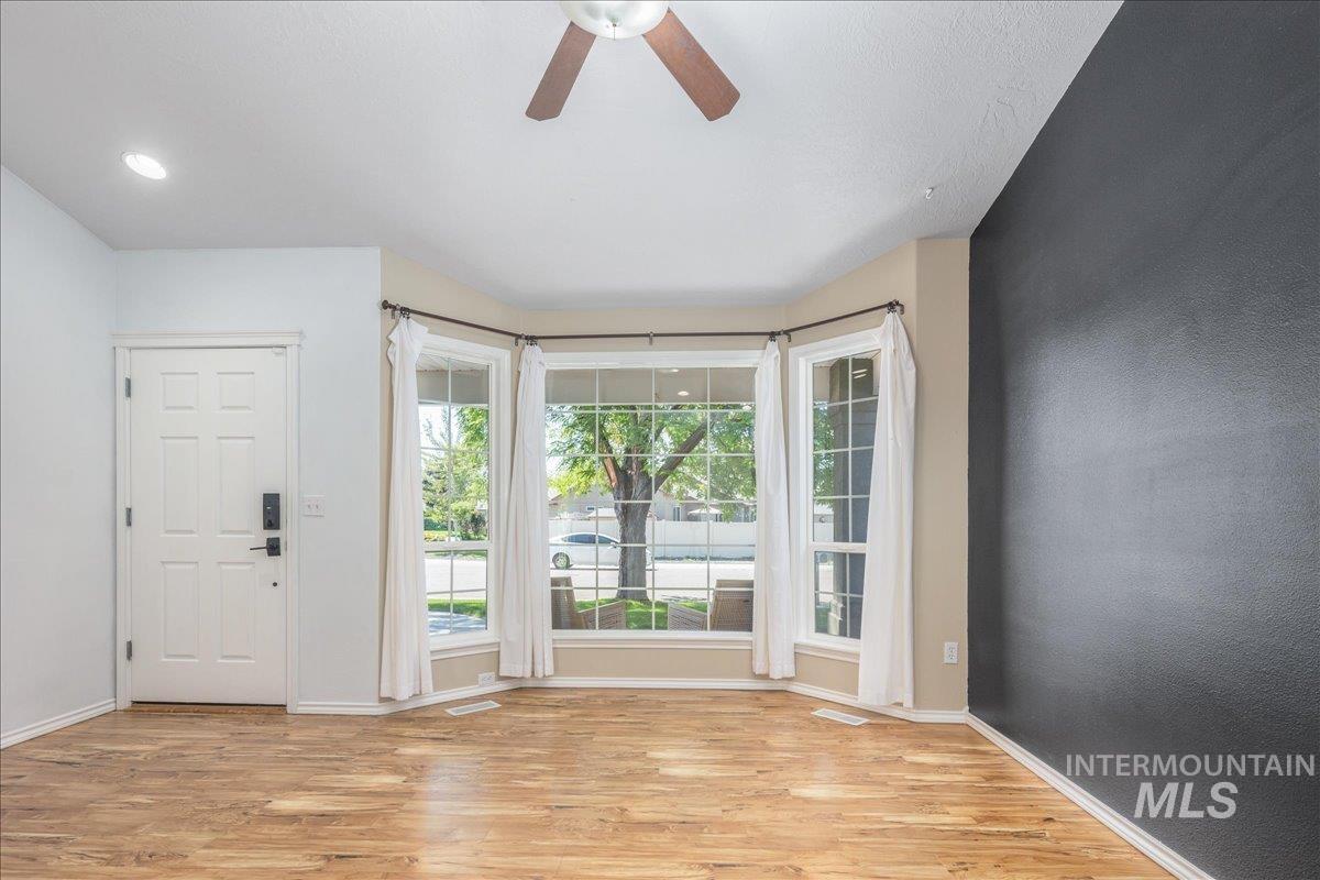 Foyer entrance with light wood-style floors, a ceiling fan, and recessed lighting