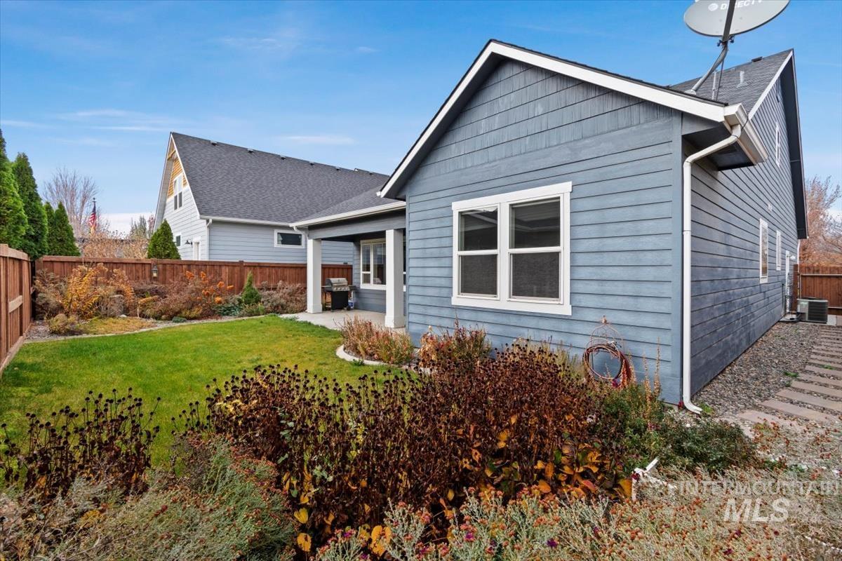 Rear view of house with a fenced backyard and a patio area