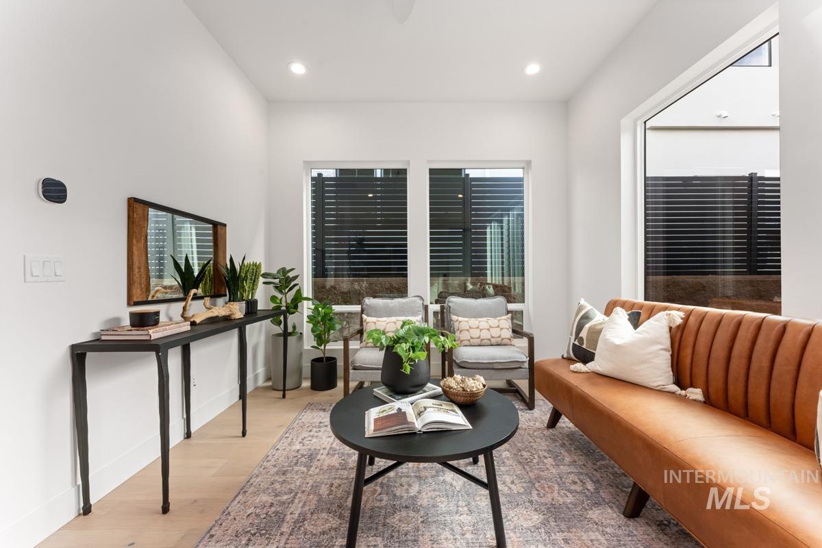 Living area featuring wood finished floors and recessed lighting