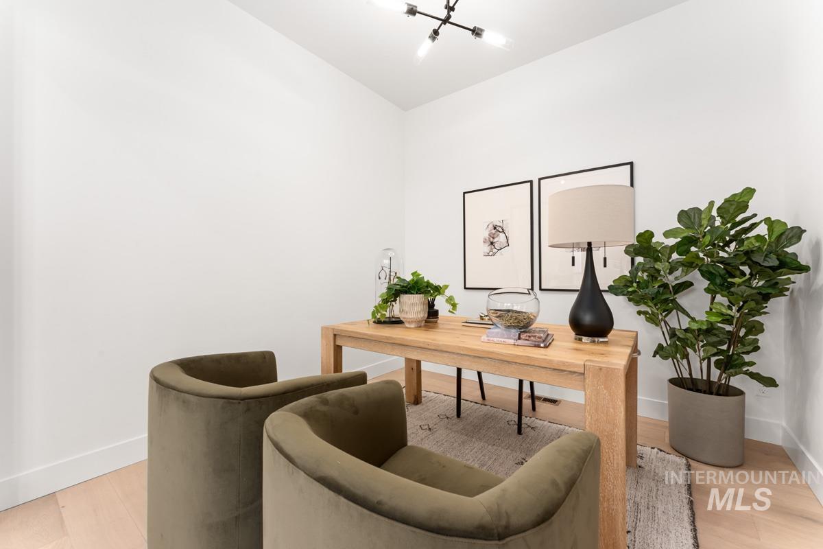 Office space with baseboards and light wood-style flooring