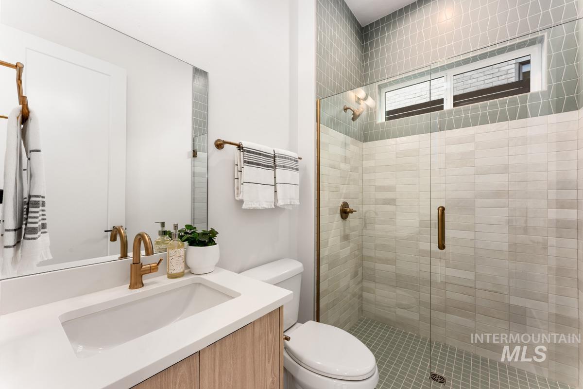 Bathroom featuring vanity and a shower stall