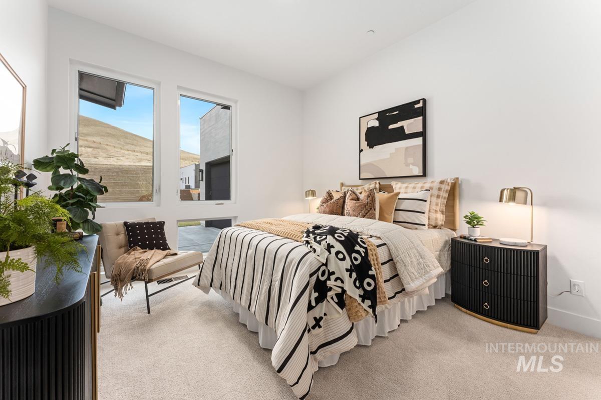 Bedroom with light colored carpet