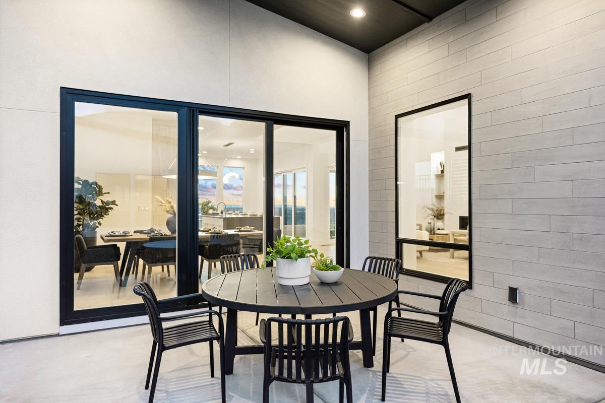 Dining room with recessed lighting, finished concrete flooring, and a high ceiling