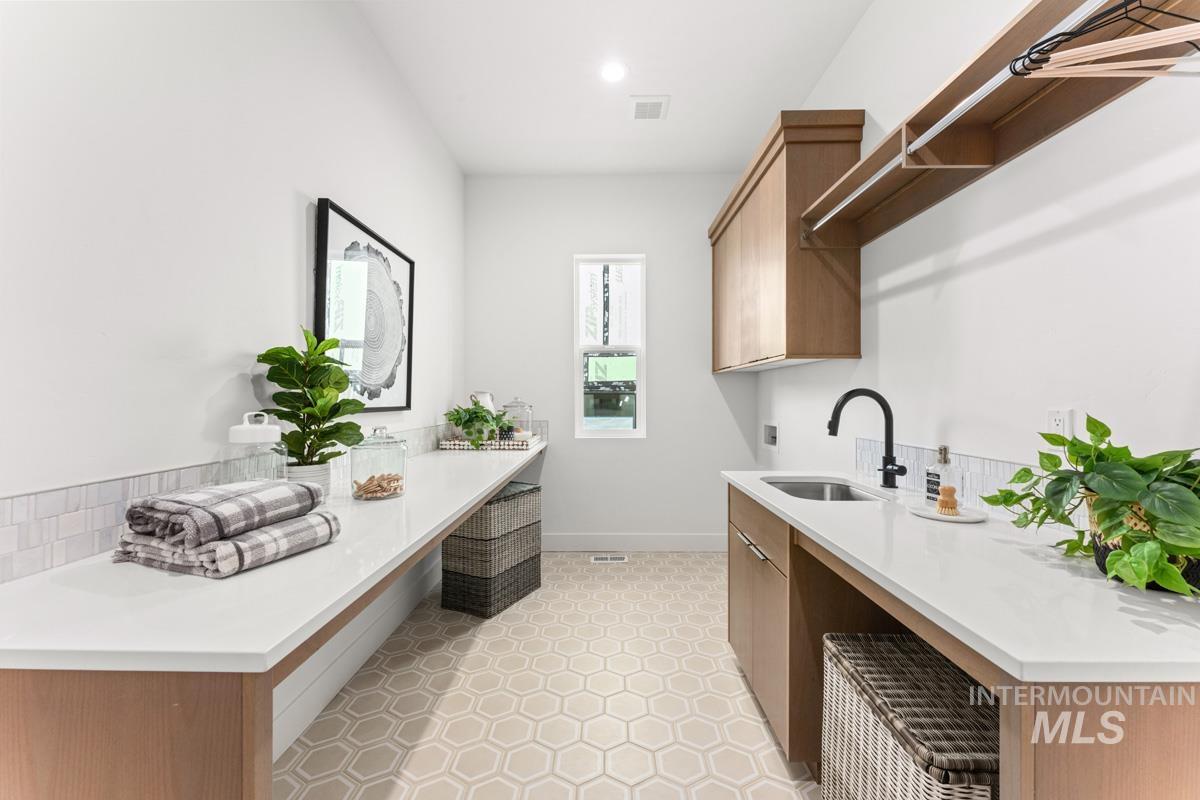 Laundry area featuring washer hookup and cabinet space