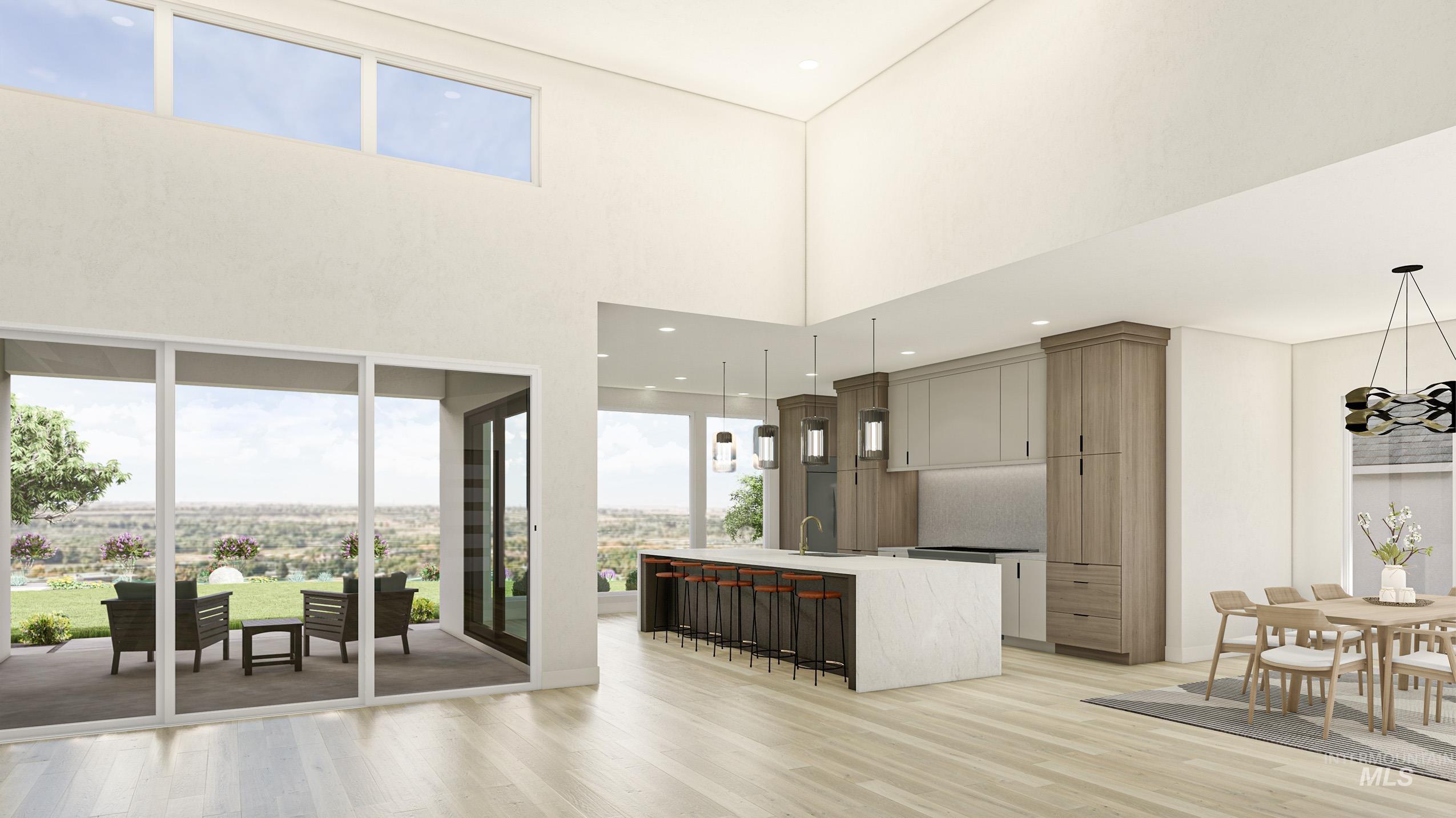 Kitchen with an island with sink, a kitchen breakfast bar, light wood finished floors, hanging lights, and light stone countertops