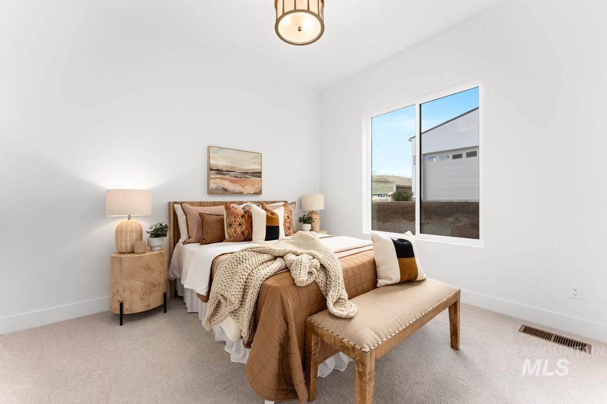 Bedroom with baseboards and carpet floors