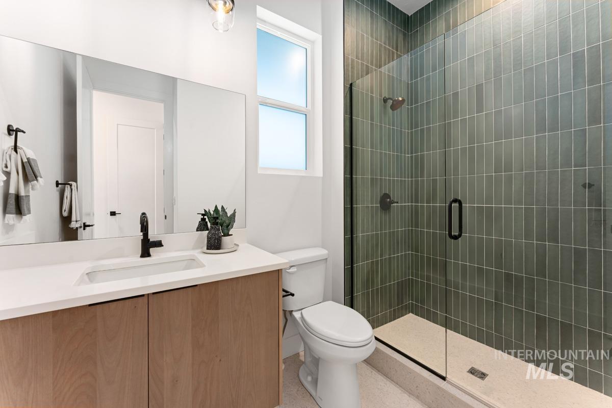 Bathroom with a shower stall and vanity