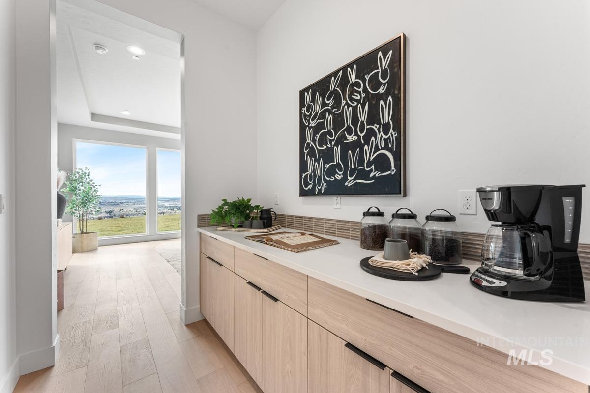 Bar featuring light wood finished floors, light wood finish cabinetry, recessed lighting, and modern cabinets