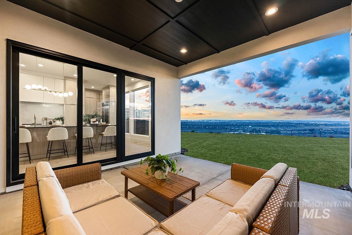 Patio terrace at dusk featuring outdoor seating, a patio, and a yard